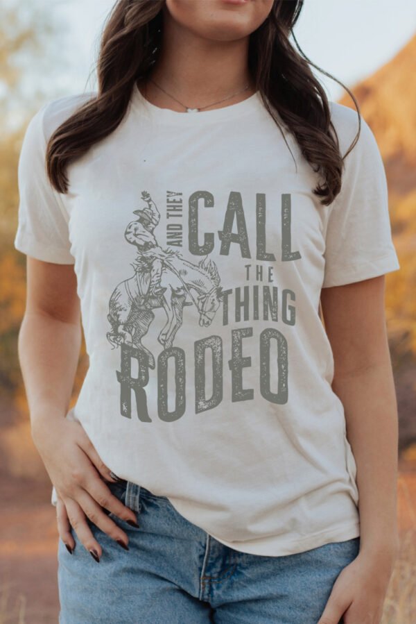 White AND THEY CALL THE THING RODEO Print Round Neck T Shirt